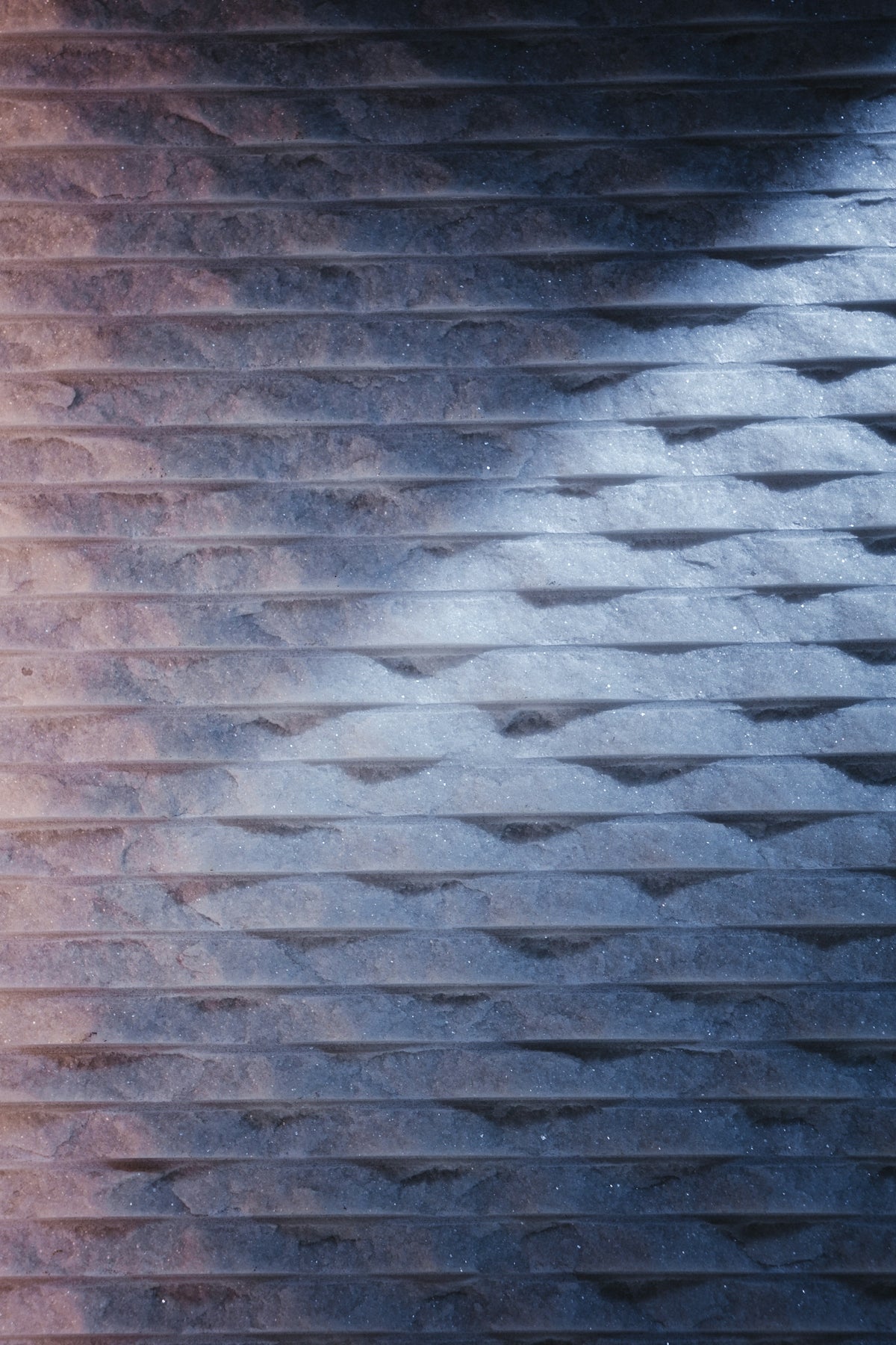 Textured dark grey wall with light shadow