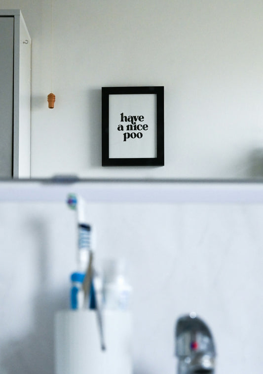 A bathroom sink with a toothbrush in it