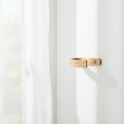 Curtain holdback with brass fittings  with curtains against a white wall