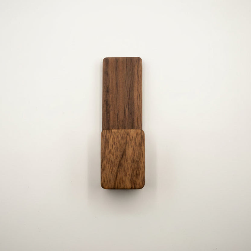 Wooden object with two different wood finishes on a white background