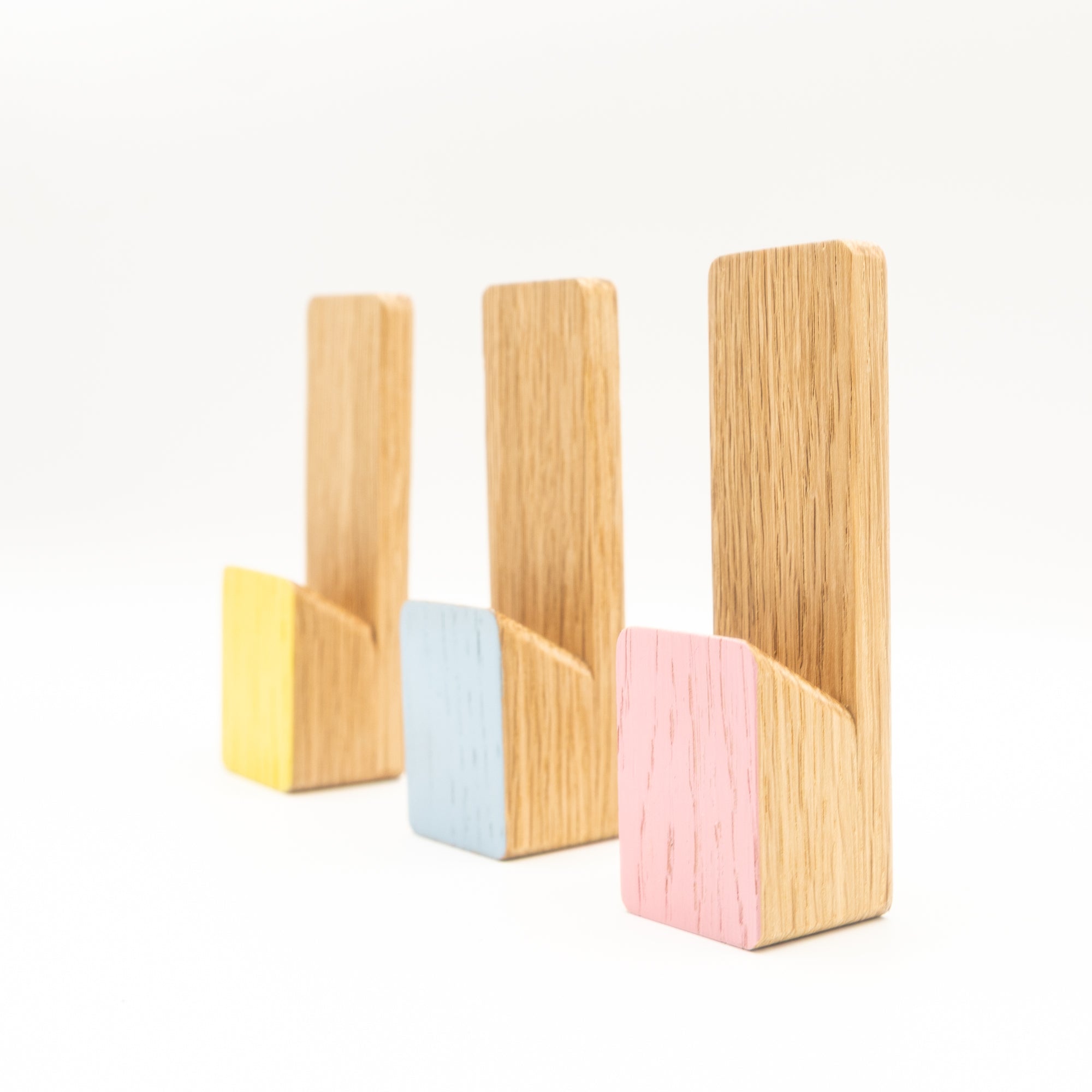 Set of four wooden bookends with colorful bases on a white background