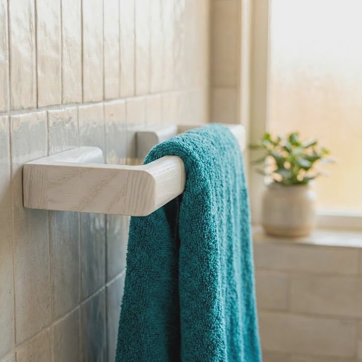 white towel rack on restroom tiles